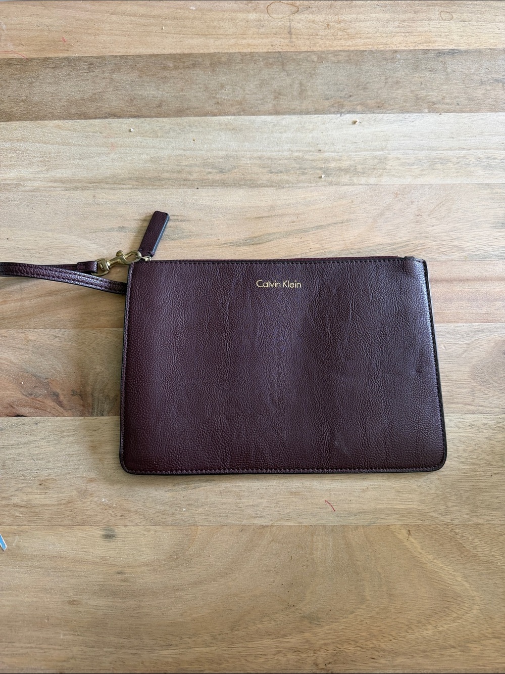 Calvin Klein Dark Brown almost maroon like Leather Wristlet Pouch with Gold Logo